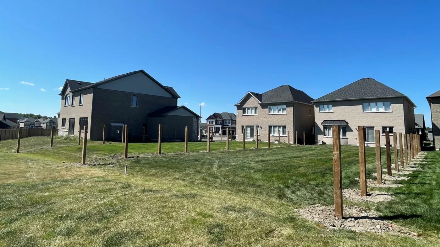 Row of fence posts set in concrete for a privacy fence in a new subdivision