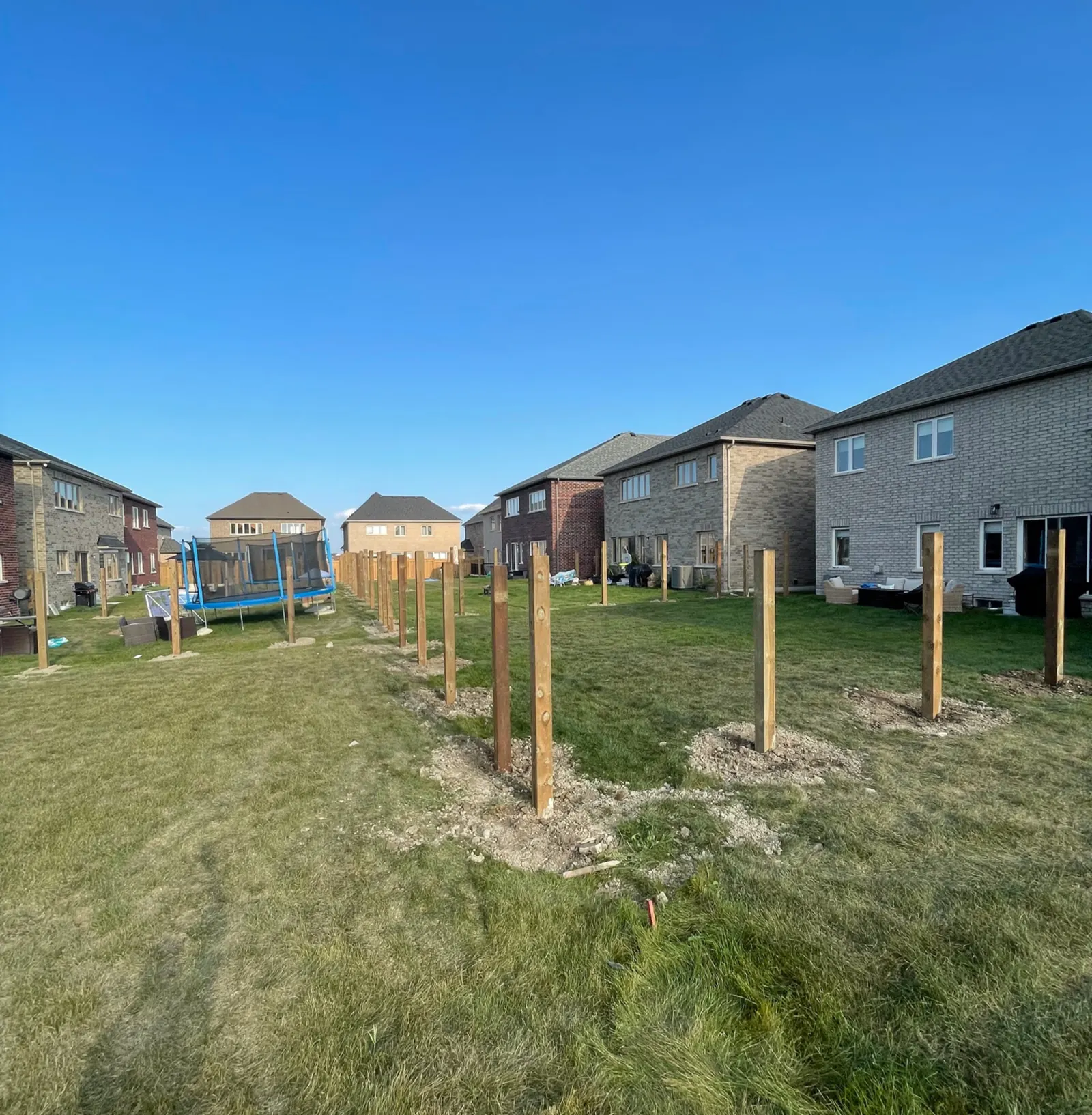 Privacy fence posts set in concrete in a new subdivision backyard